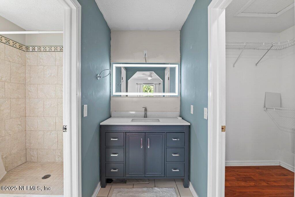 11631 East Ride Drive Jacksonville, FL 32223 - Photo 12 of 28 a bathroom with a granite countertop sink mirror and vanity