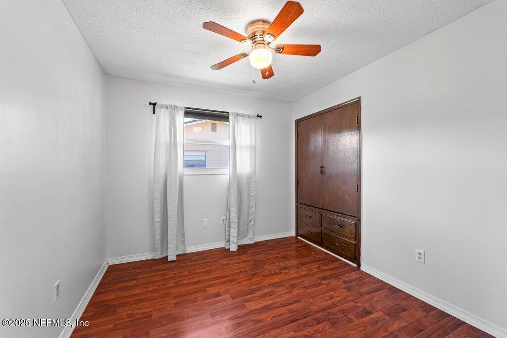 11631 East Ride Drive Jacksonville, FL 32223 - Photo 14 of 28 a bedroom with a bed and a chandelier fan