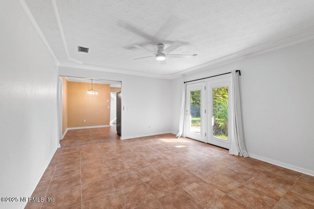 11631 East Ride Drive Jacksonville, FL 32223 - Photo 16 of 28 an empty room with windows and a ceiling fan