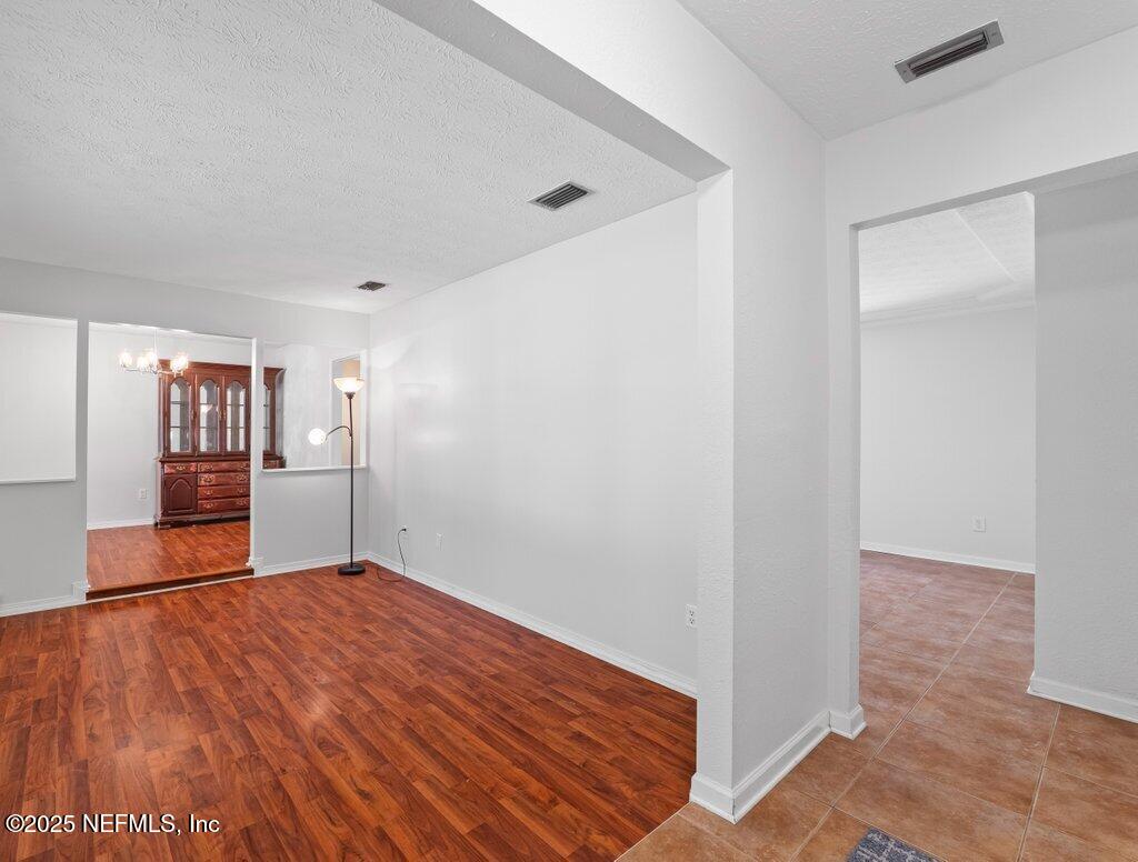 11631 East Ride Drive Jacksonville, FL 32223 - Photo 17 of 28 a view of an empty room with wooden floor