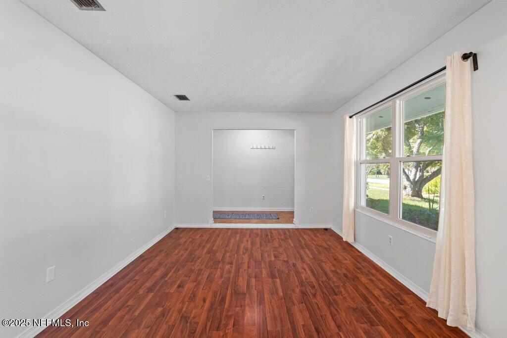 11631 East Ride Drive Jacksonville, FL 32223 - Photo 20 of 28 a view of a room with wooden floor and windows
