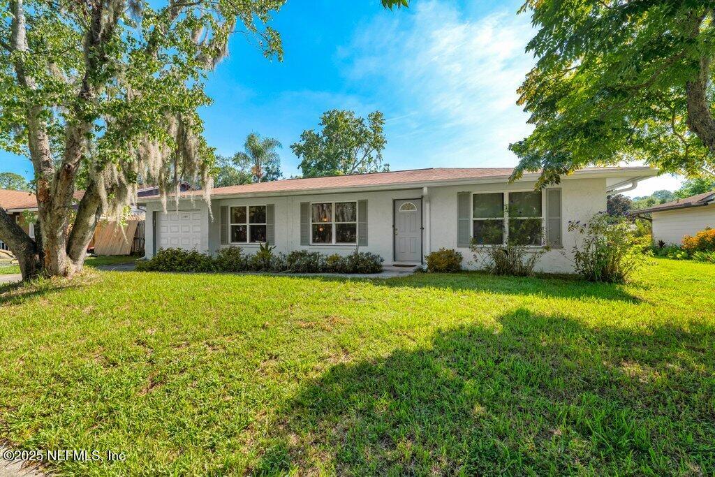 11631 East Ride Drive Jacksonville, FL 32223 - Photo 2 of 28 a view of a house with backyard and garden