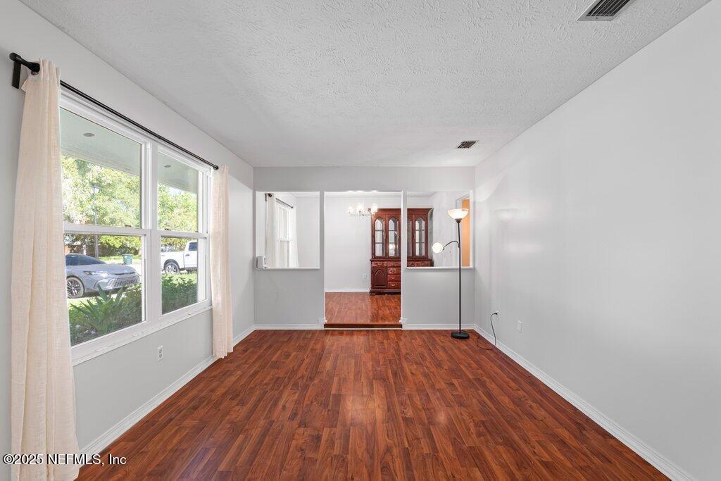 11631 East Ride Drive Jacksonville, FL 32223 - Photo 21 of 28 a view of empty room with wooden floor and fan