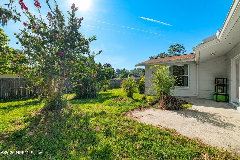11631 East Ride Drive Jacksonville, FL 32223 - Photo 27 of 28 a view of a backyard with plants and a patio