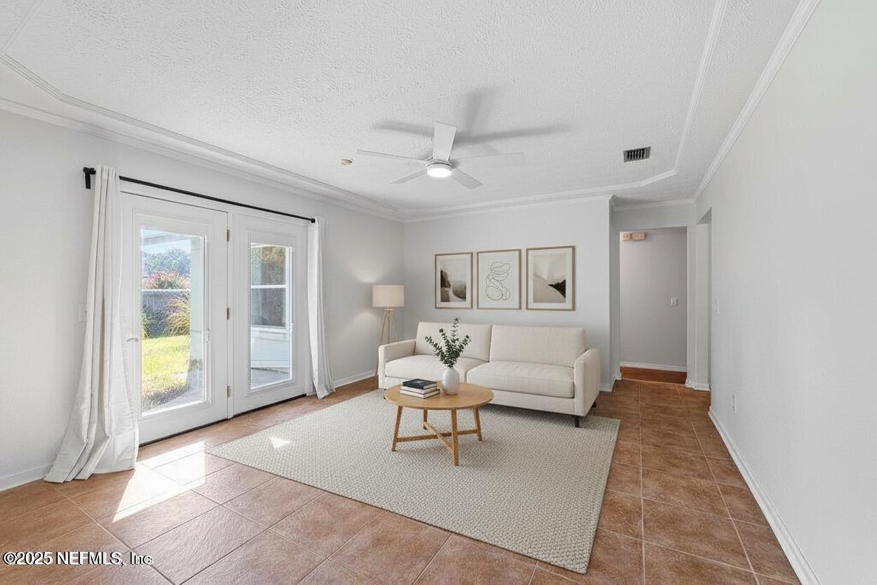 11631 East Ride Drive Jacksonville, FL 32223 - Photo 3 of 28 a living room with furniture and chandelier