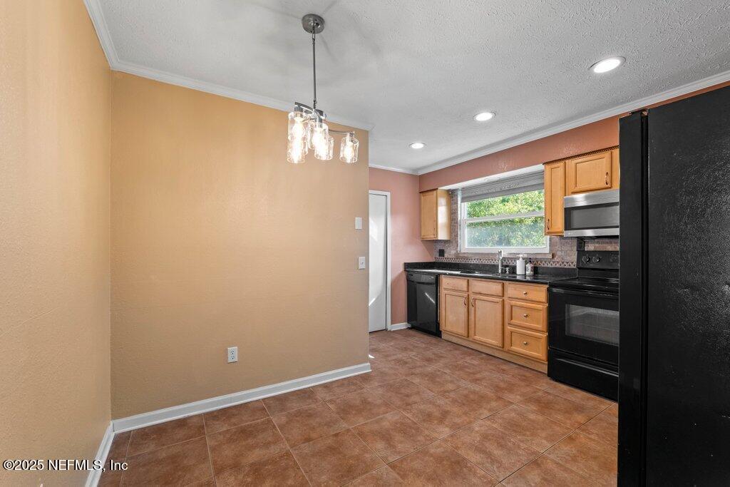 11631 East Ride Drive Jacksonville, FL 32223 - Photo 8 of 28 a kitchen with stainless steel appliances granite countertop a stove a sink and a refrigerator