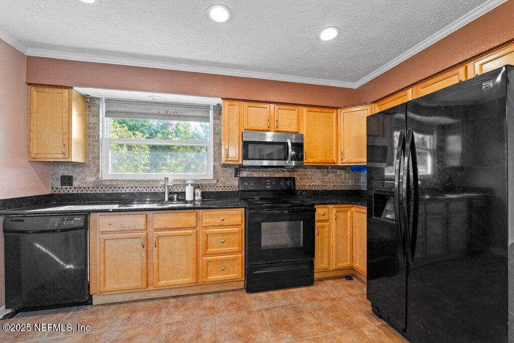 11631 East Ride Drive Jacksonville, FL 32223 - Photo 9 of 28 a kitchen with stainless steel appliances granite countertop a refrigerator and a sink