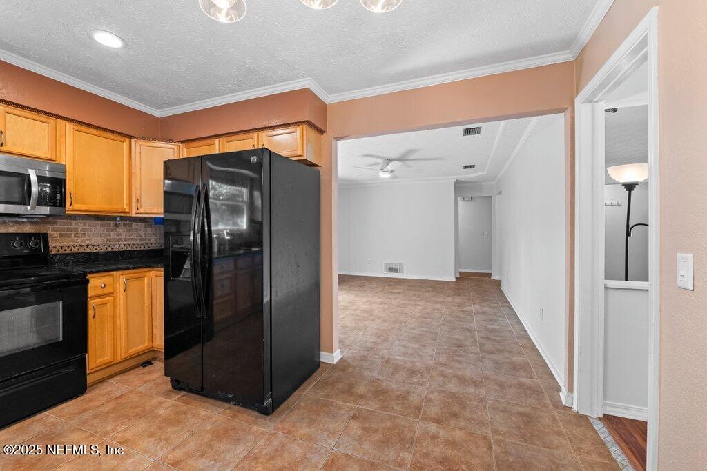 11631 East Ride Drive Jacksonville, FL 32223 - Photo 10 of 28 a view of a refrigerator in kitchen and a window