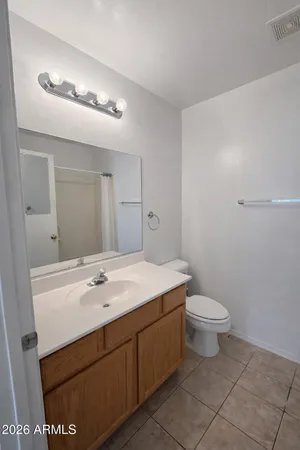 a bathroom with a sink a toilet and mirror