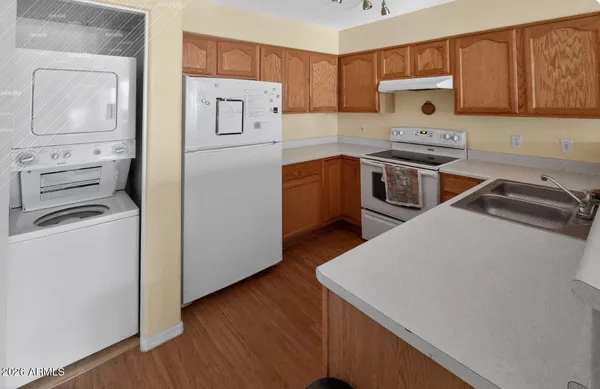 a kitchen with a refrigerator a stove a microwave and cabinets