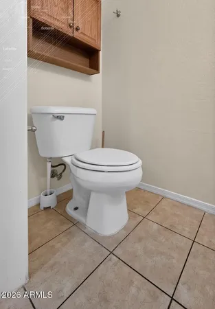 a bathroom with a toilet a sink and a mirror