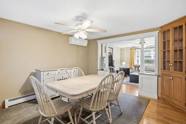 a view of a dining room with furniture window and wooden floor