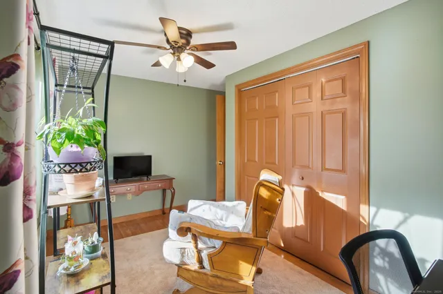 a view of a workspace with furniture and a window