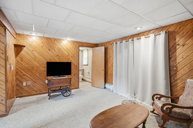 a view of a livingroom with workspace and a window
