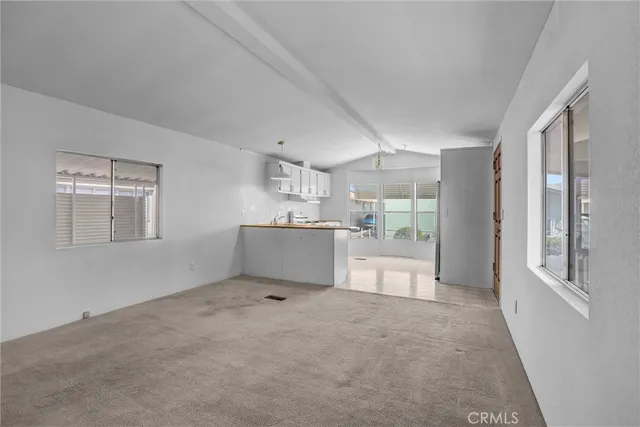 a big room with chandelier and windows