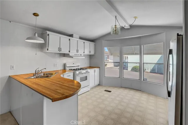 a kitchen with stainless steel appliances granite countertop a sink and cabinets