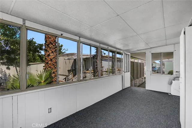 a hallway with a large window and couch