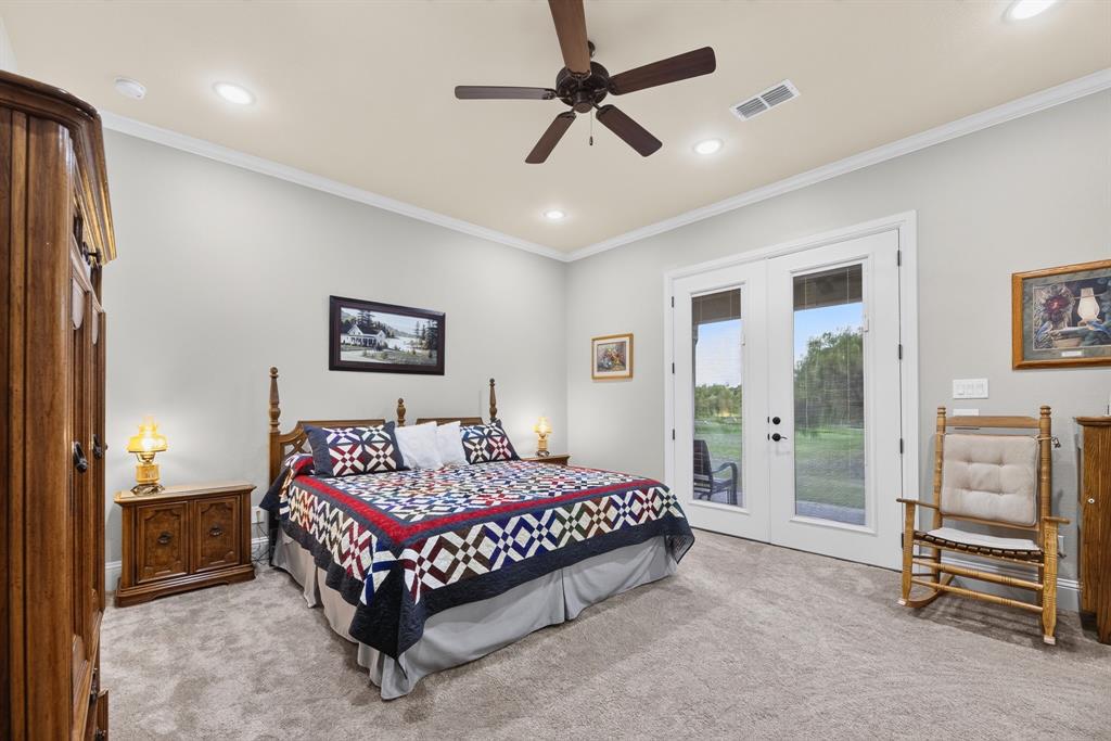 985 Vest Lane Pilot Point, TX 76258 - Photo 36 of 40 Bedroom featuring light gray walls, plush gray carpeting, and a ceiling fan with integrated lighting