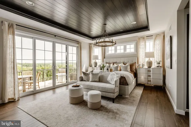 a bedroom with furniture and a large window