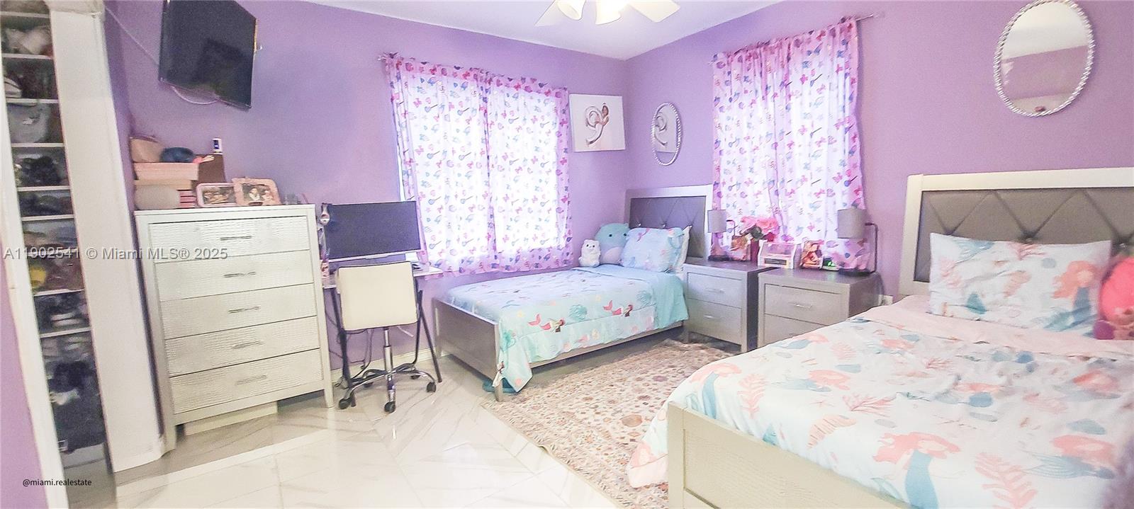 232 Northeast 160th Street Miami, FL 33162 - Photo 13 of 36 a bedroom with a bed and a dresser