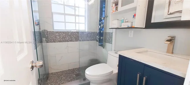 a bathroom with a sink toilet and window
