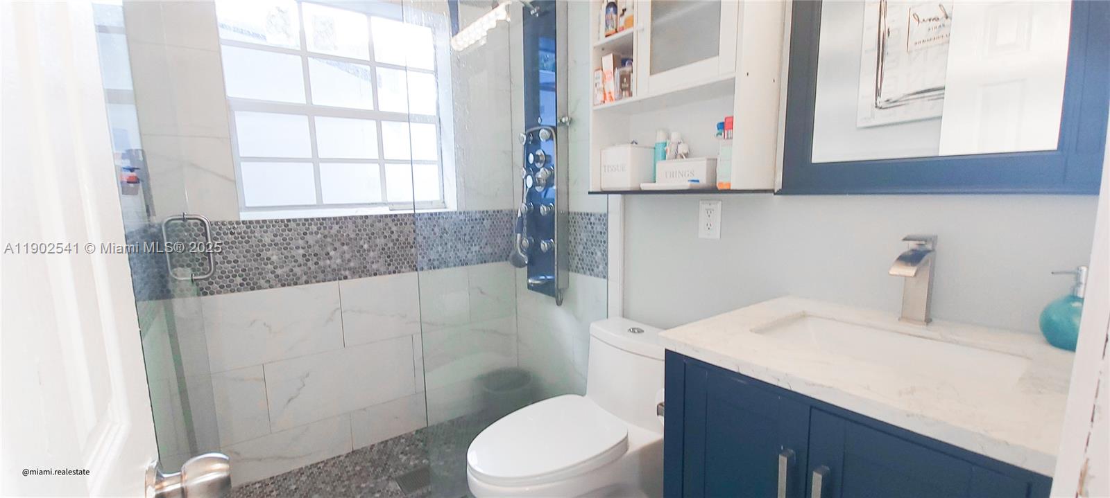 232 Northeast 160th Street Miami, FL 33162 - Photo 19 of 36 a bathroom with a sink a toilet and a window