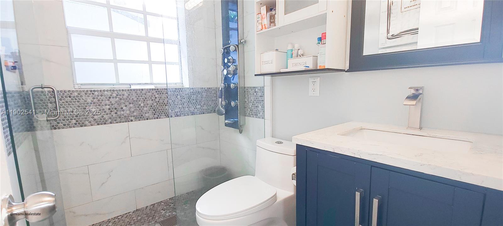 232 Northeast 160th Street Miami, FL 33162 - Photo 20 of 36 a bathroom with a sink a toilet and shower