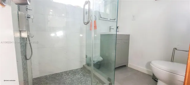 a bathroom with a shower and a toilet