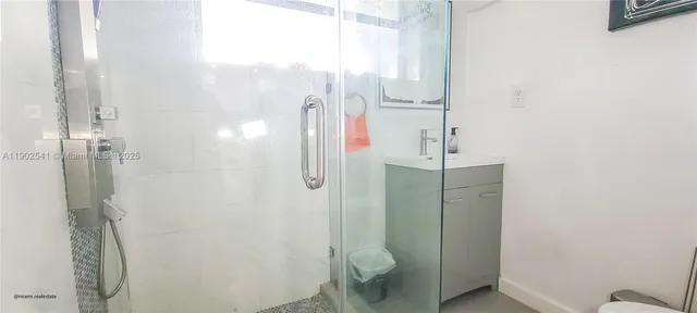 a bathroom with a shower and toilet