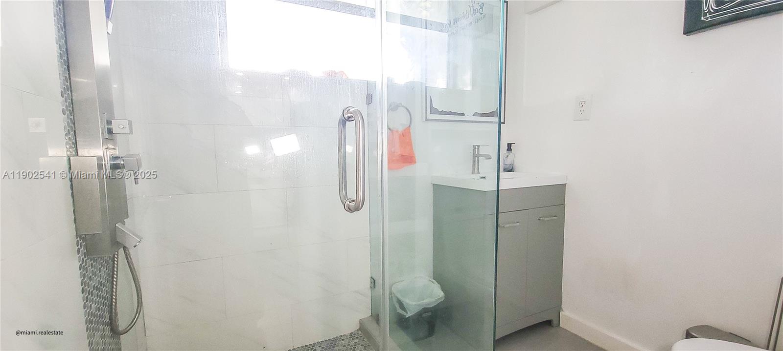 232 Northeast 160th Street Miami, FL 33162 - Photo 23 of 36 a bathroom with a shower and toilet