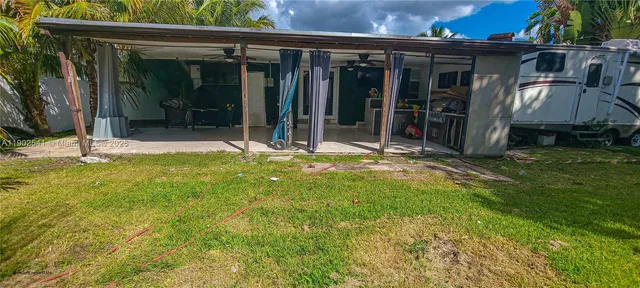 a view of a house with backyard and porch