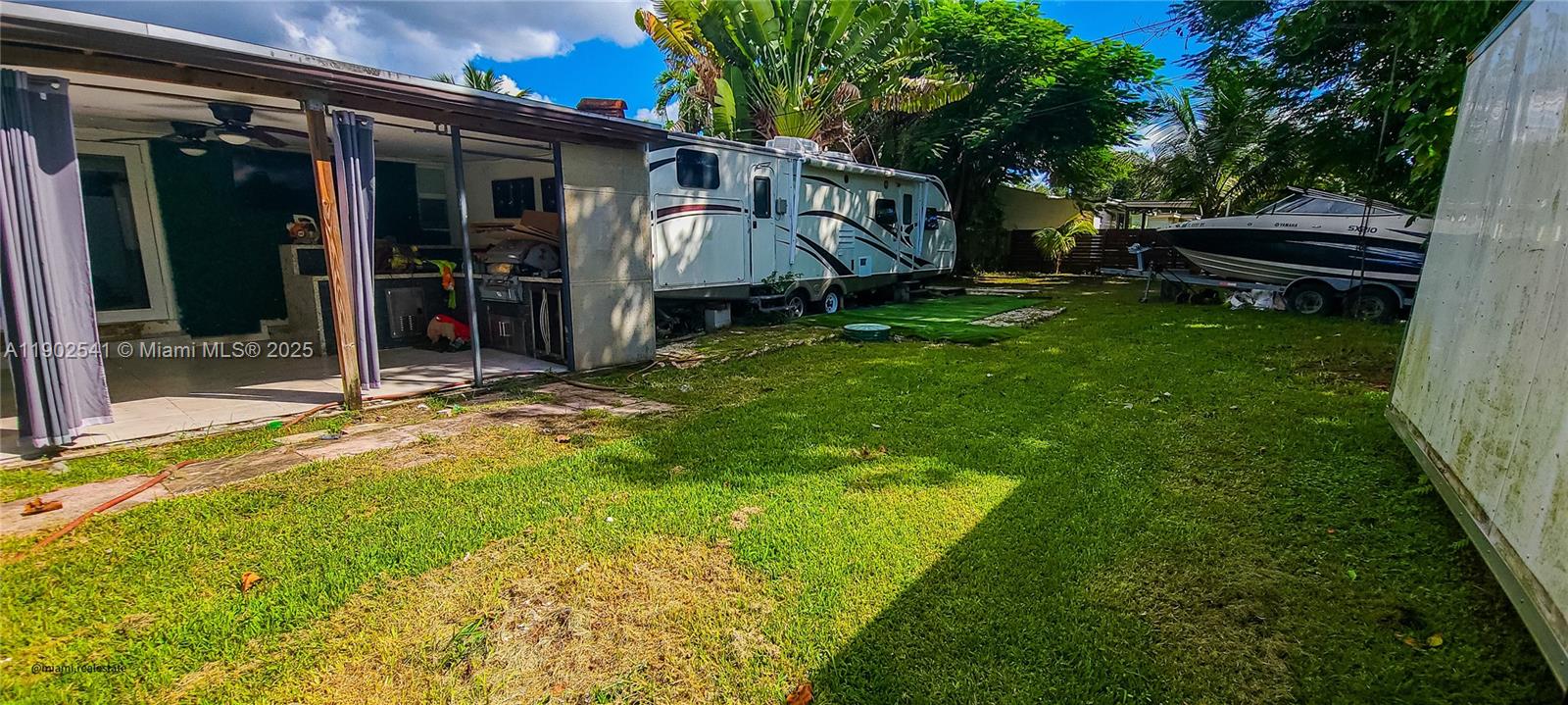 232 Northeast 160th Street Miami, FL 33162 - Photo 31 of 36 a view of a house with backyard and sitting area
