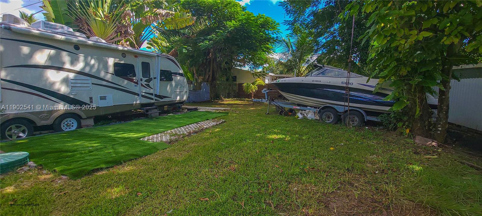 232 Northeast 160th Street Miami, FL 33162 - Photo 34 of 36 a backyard of a house with fountain table and chairs