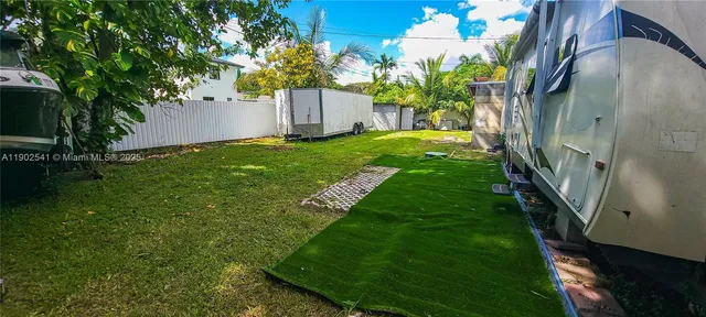 a view of yard in front of house with trees