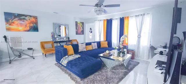 a living room with furniture and large windows