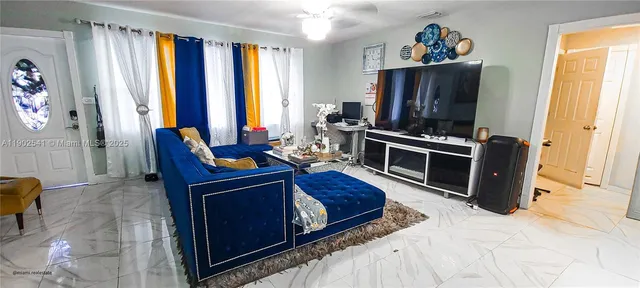 a living room with furniture and a flat screen tv