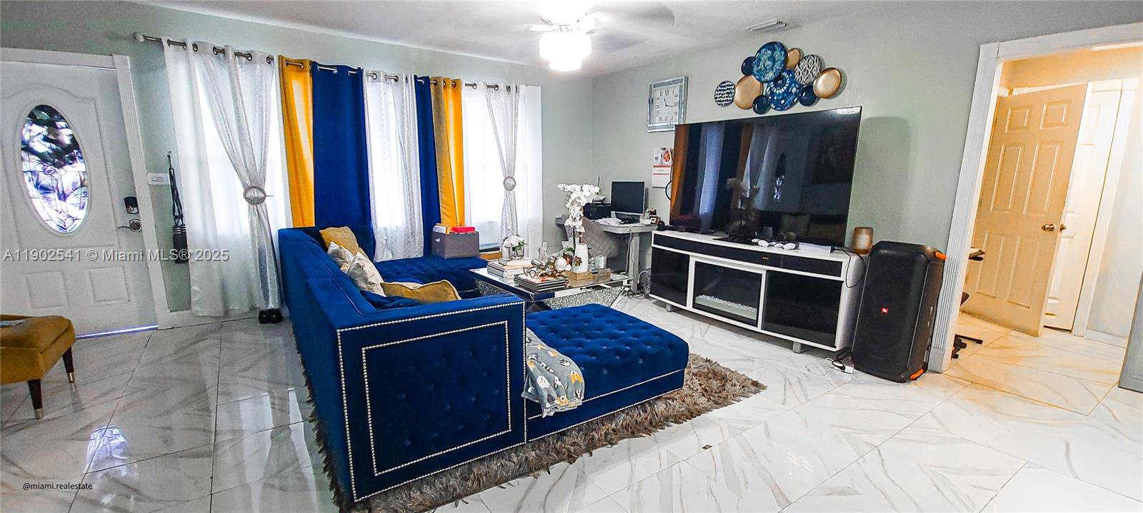 232 Northeast 160th Street Miami, FL 33162 - Photo 6 of 36 a living room with furniture and a flat screen tv