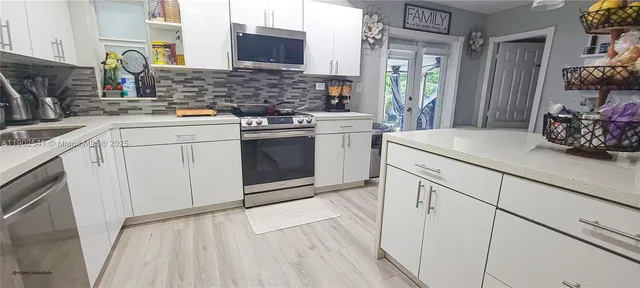 a kitchen with a sink stove and cabinets
