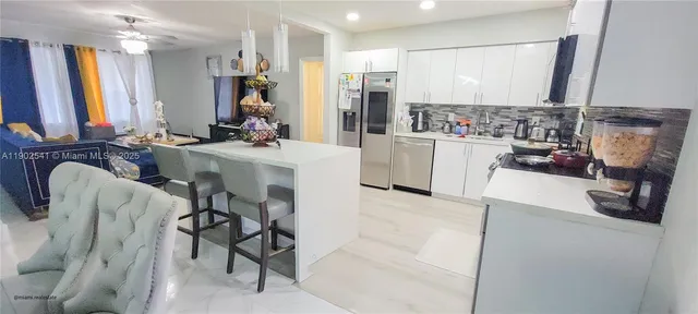 a view of kitchen and living room with a couch