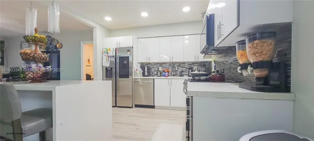 a view of kitchen with furniture and wooden floor