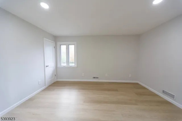 a view of a house with a wooden deck