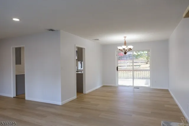 a kitchen with a refrigerator and a stove top oven