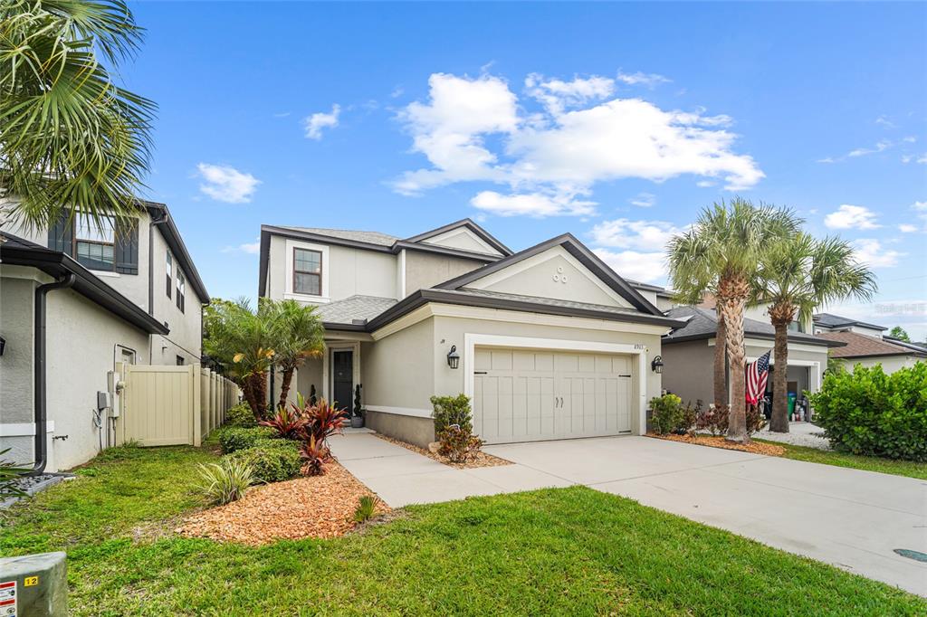 8903 Arabella Lane Seminole, FL 33777 - Photo 5 of 47 a view of a white house next to a yard and a large tree