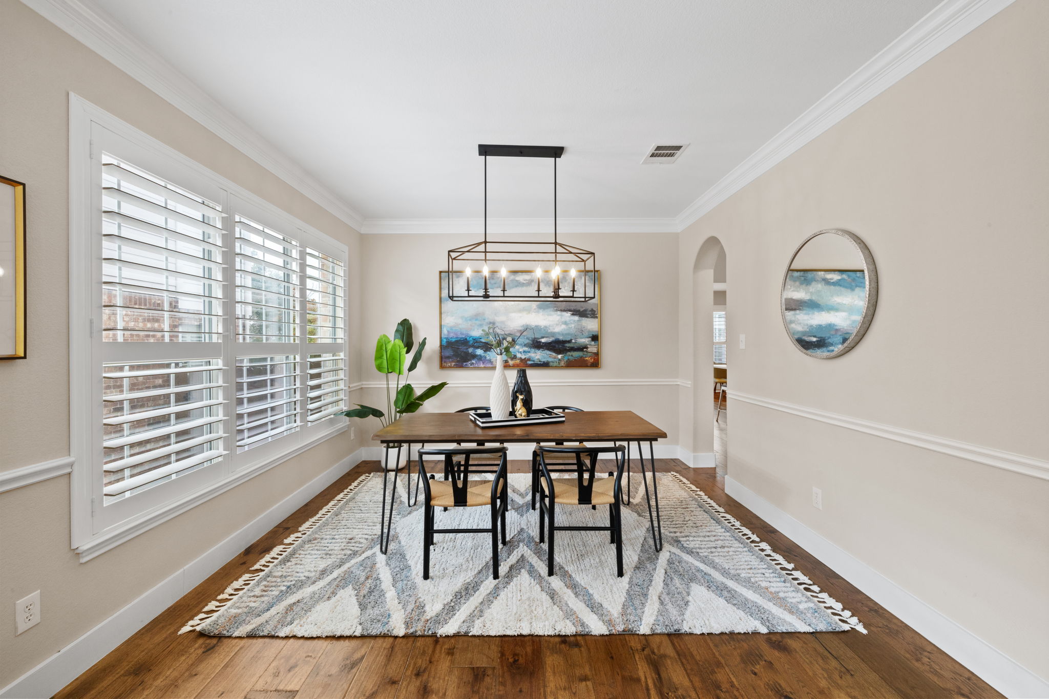 8112 Cobblestone Austin, TX 78735 - Photo 6 of 33 Dining room featuring arched walkways, wood finished floors, plenty of natural light, a chandelier, and crown molding