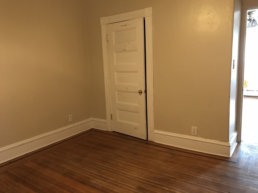 682 2nd Street Fall River, MA 02721 - Photo 8 of 12 a view of an empty room with wooden floor and entrance