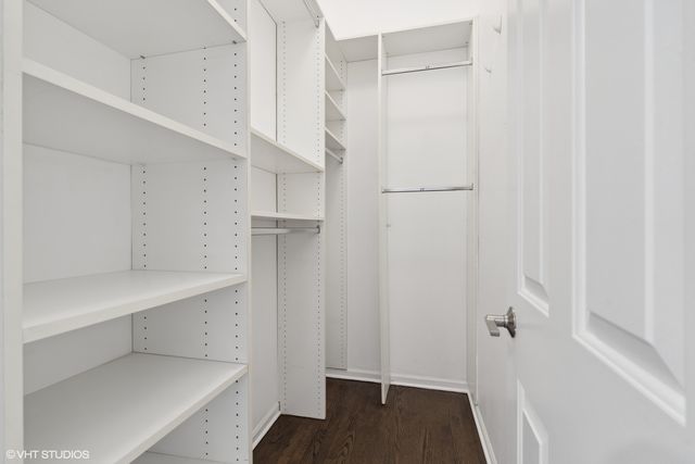 a view of walk in closet with empty racks