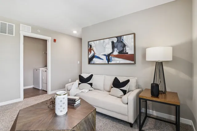a living room with furniture and a lamp