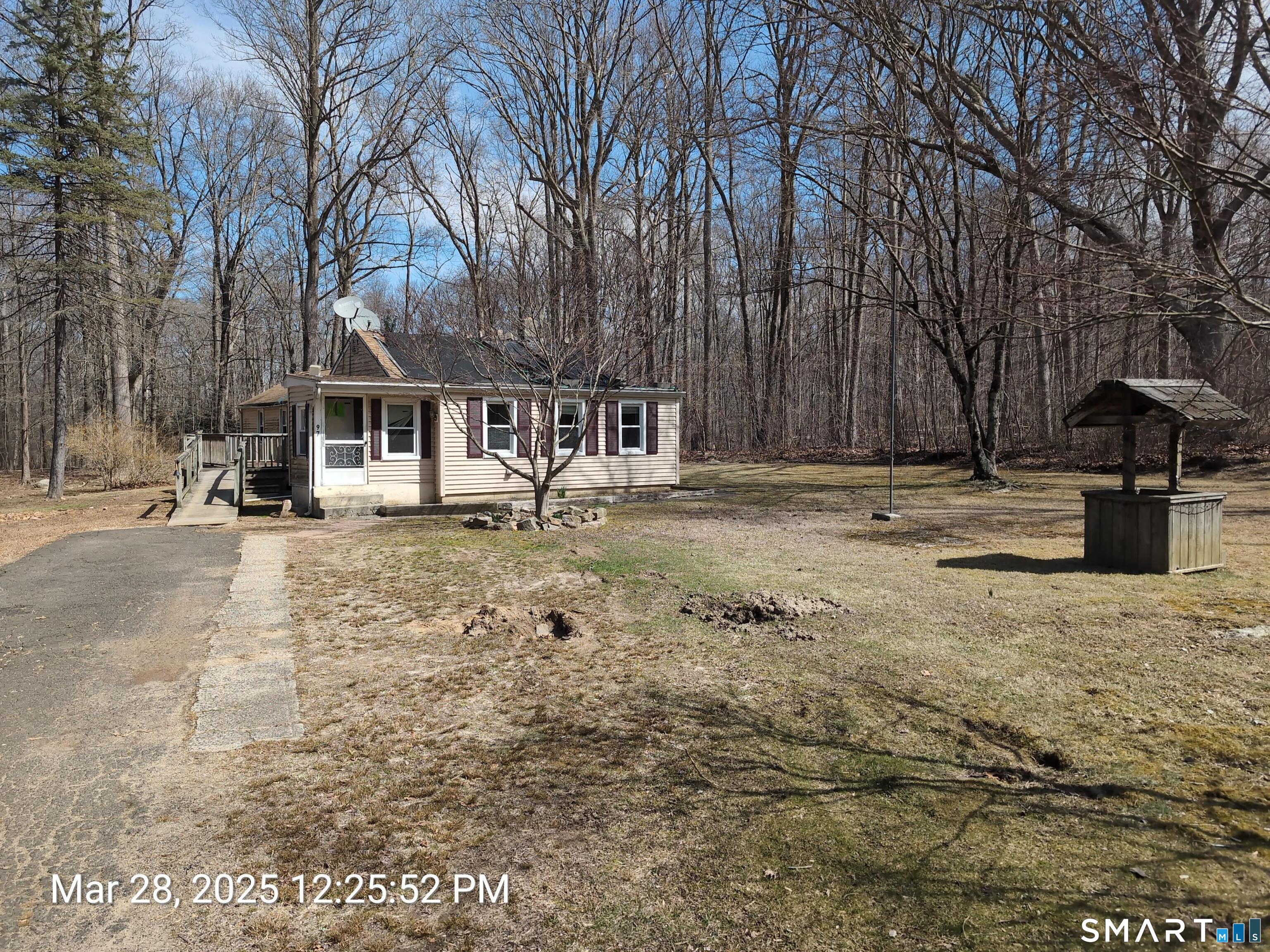 97 Bushy Hill Road Deep River, CT 06417 - Photo 1 of 28 a front view of a house with a yard covered with snow