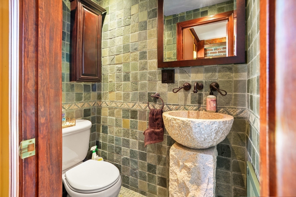 131 Perkins Street, Unit 131 Boston, MA 02130 - Photo 8 of 21 a bathroom with a granite countertop sink toilet and shower