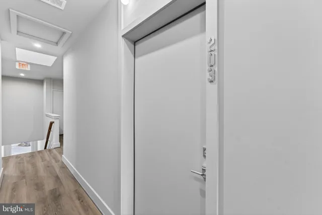 a view of a hallway with wooden floor